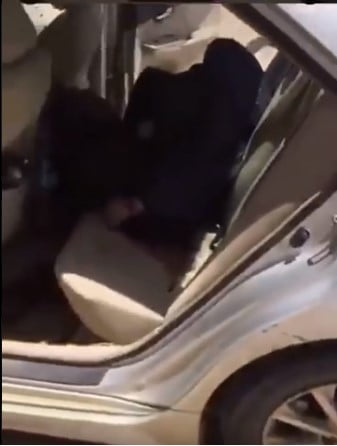 One dead body can be seen in the back seat of the car