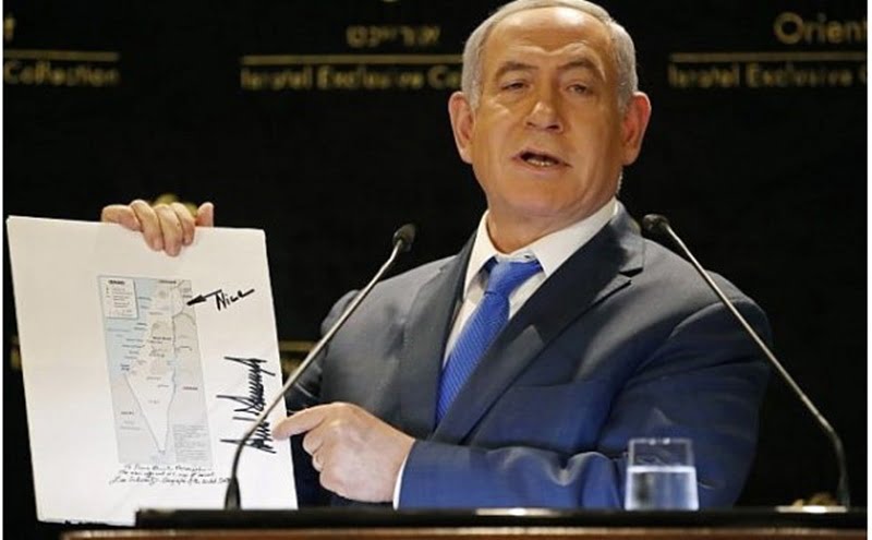 Benjamin Netanyahu beams holding the map