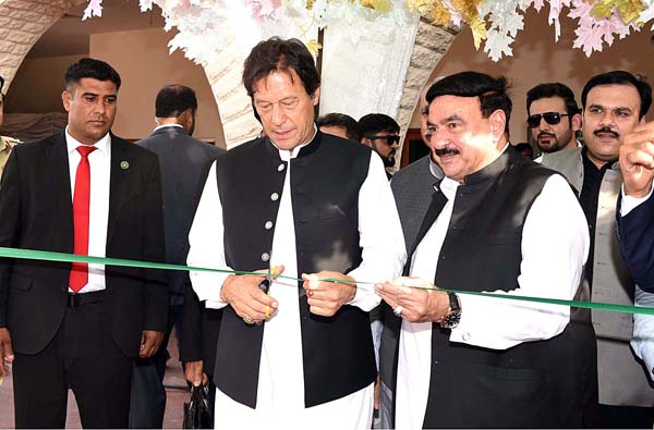 RAWALPINDI: July 03 - Prime Minister Imran Khan cutting the ribbon to inaugurate Sir Syed Express during a ceremony at Railway Station. 